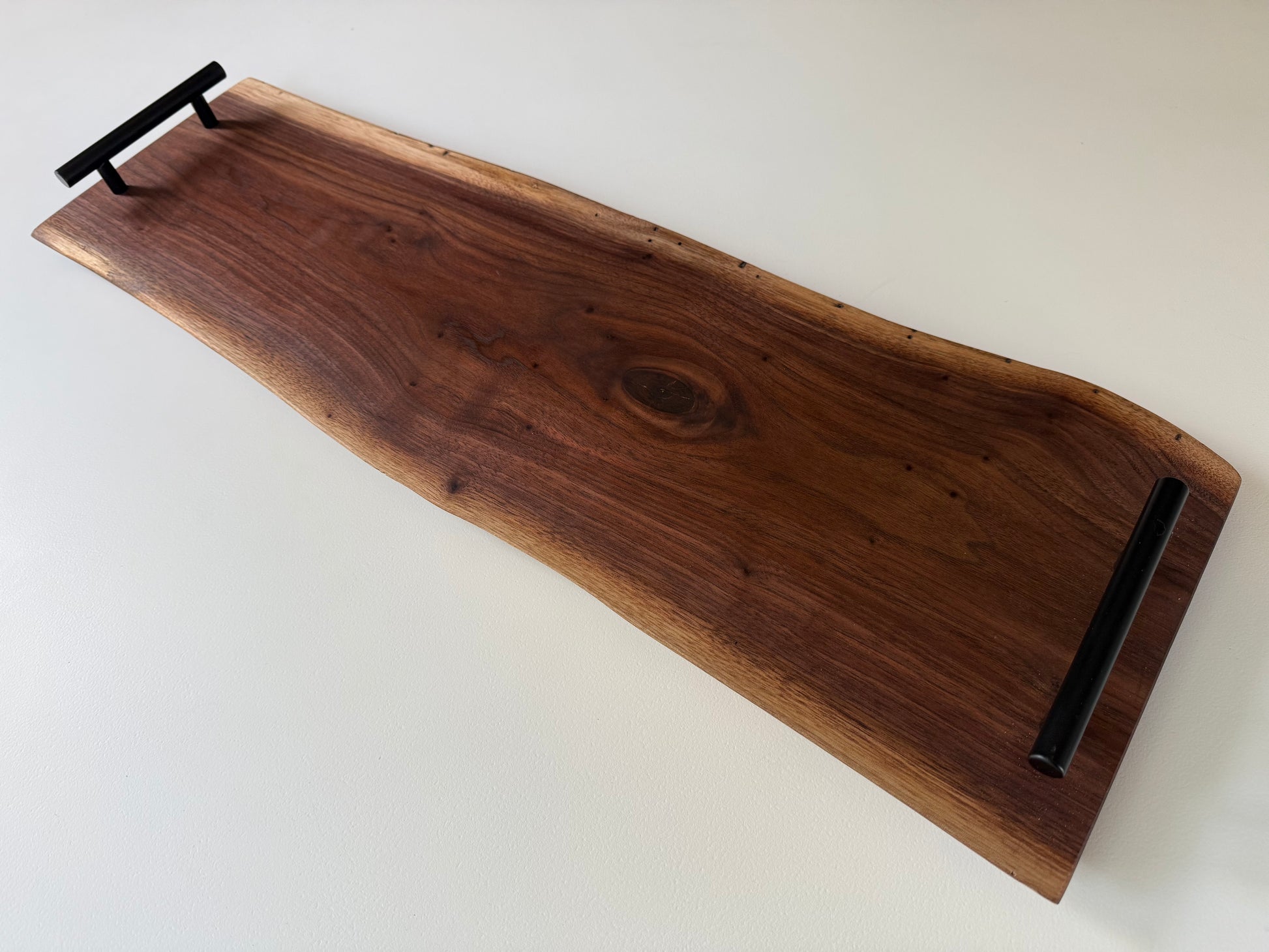 Spalted walnut charcuterie board with black handles 