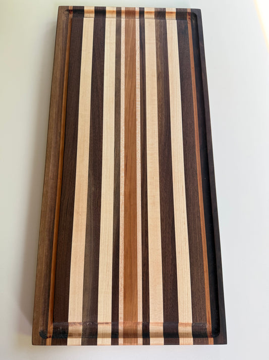 Wooden cutting board with striped pattern on a white background