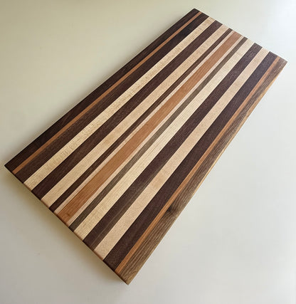 Wooden cutting board with striped pattern on a white background
