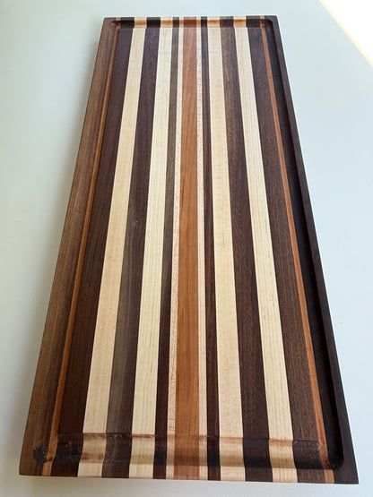Wooden cutting board with striped pattern on a white background