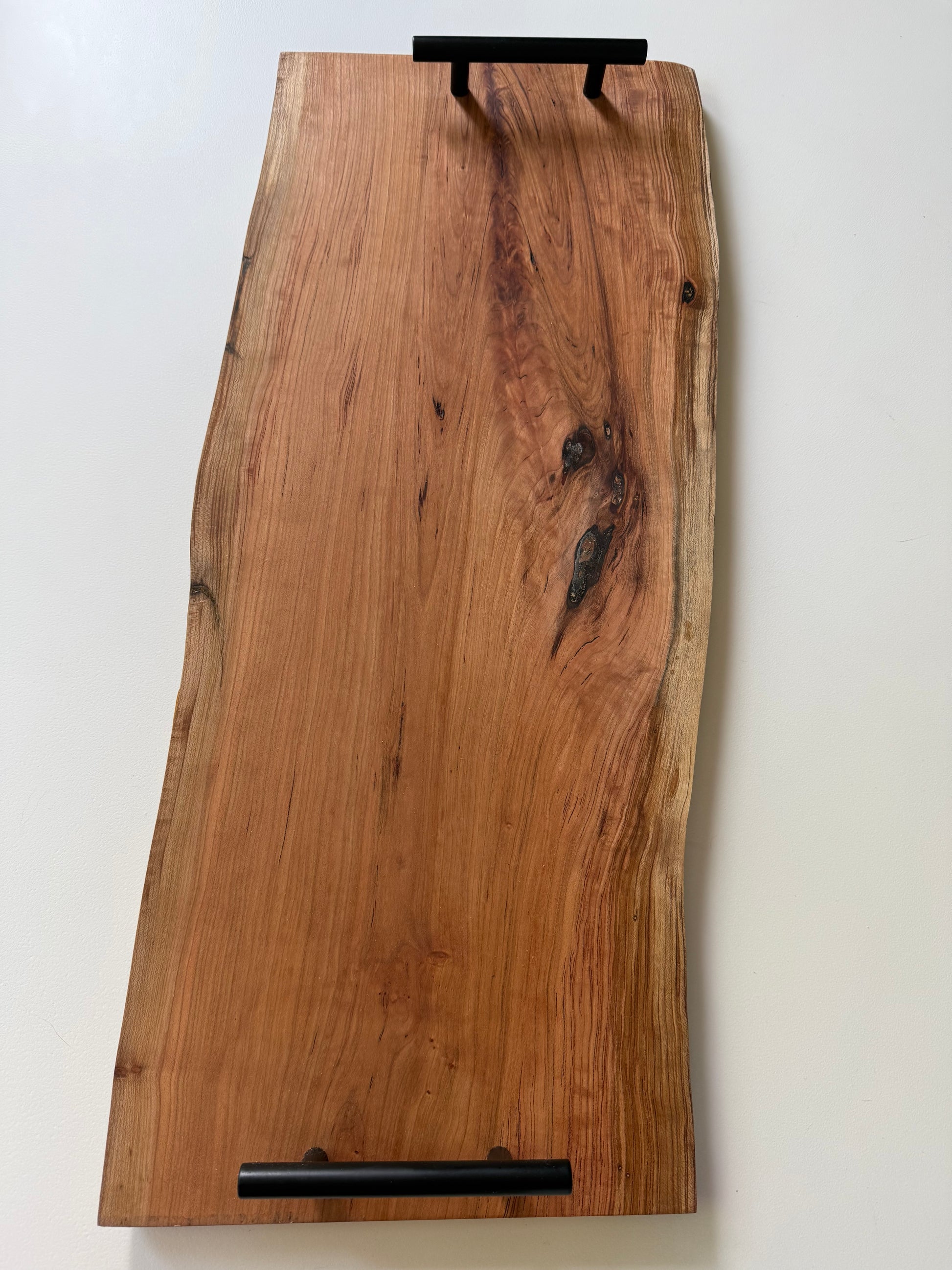 Wooden charcuterie board with black handles