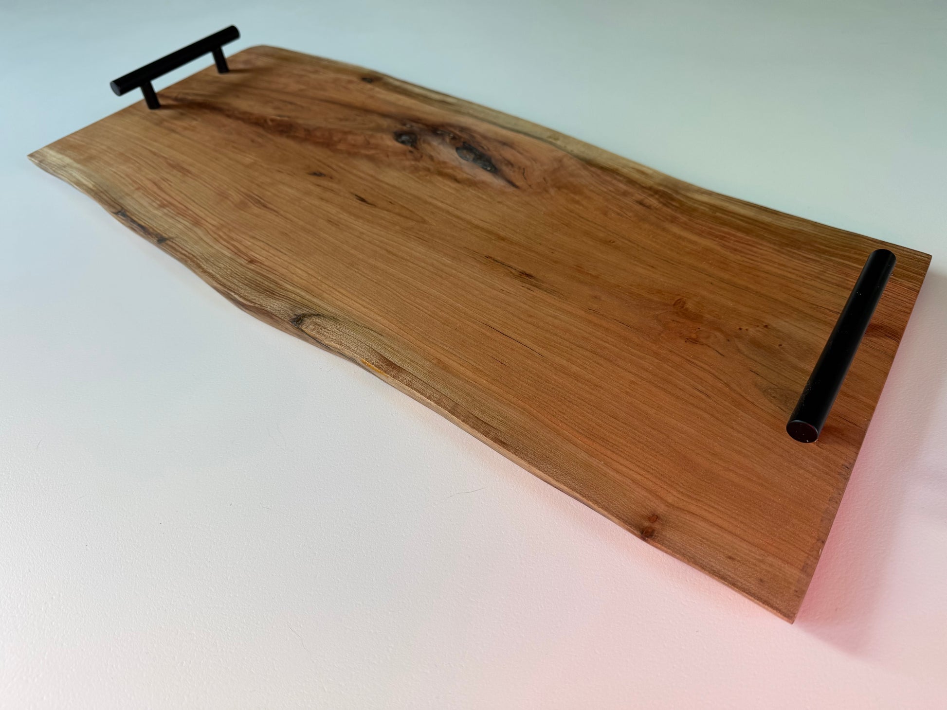 Wooden charcuterie board with black handles