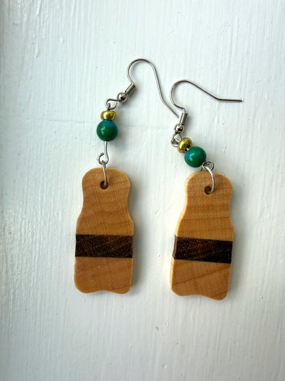 Wooden earrings with brown stripes on a white background