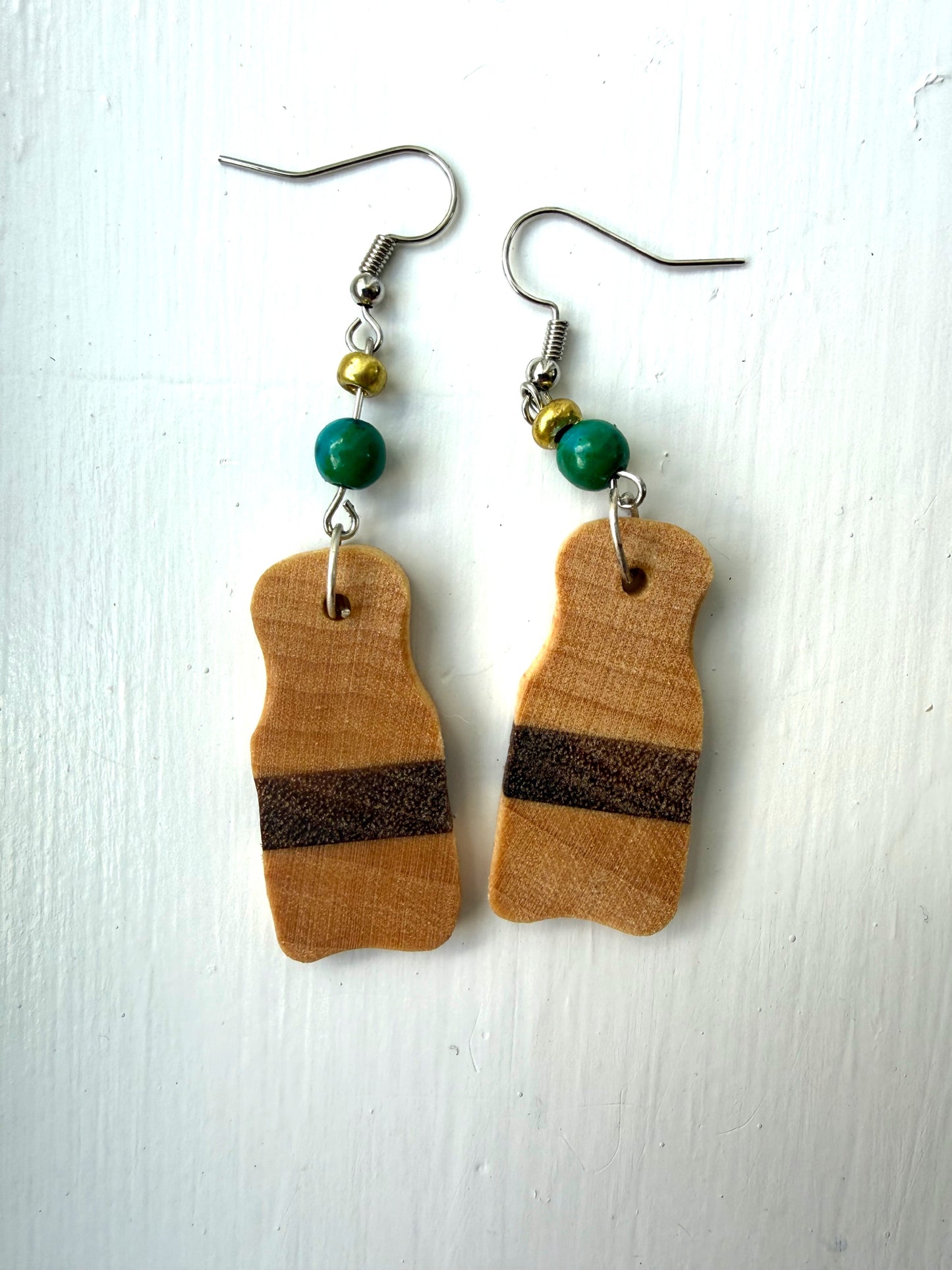 Wooden earrings with brown stripes on a white background