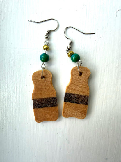 Wooden earrings with brown stripes on a white background