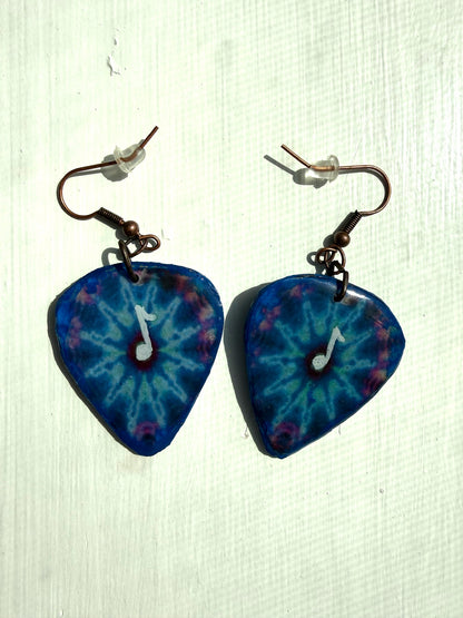 Blue tie-dye earrings with a music note design on a white background