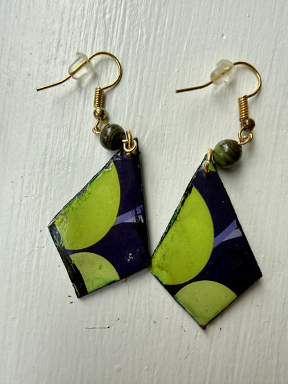 Pair of earrings with green, purple, and black geometric design on each one