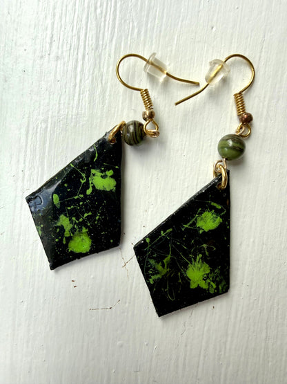 Pair of earrings with black and green marbled design on each one