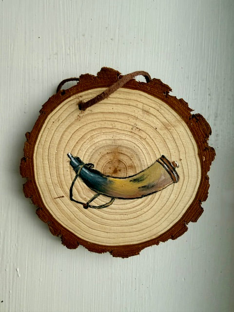 Wooden ornament featuring a powder horn