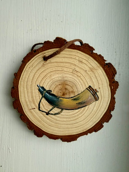 Wooden ornament featuring a powder horn
