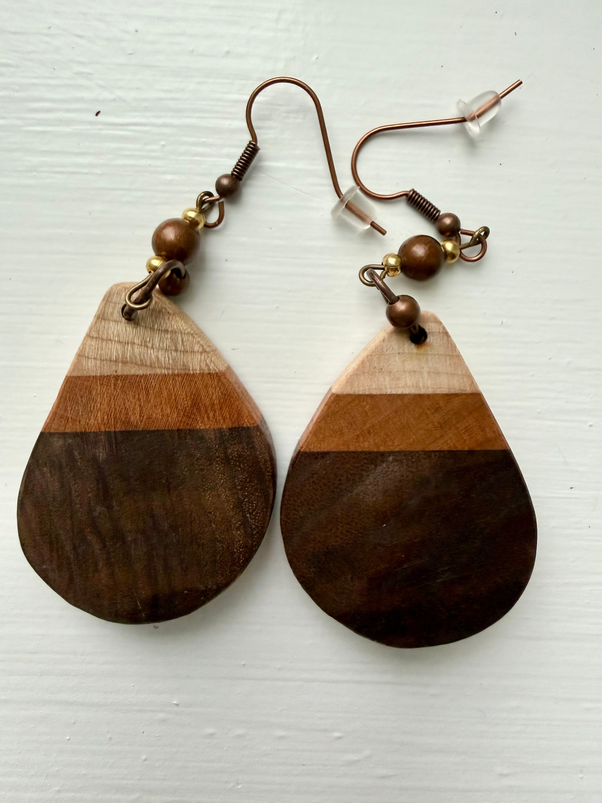 Striped wooden earrings on a white background