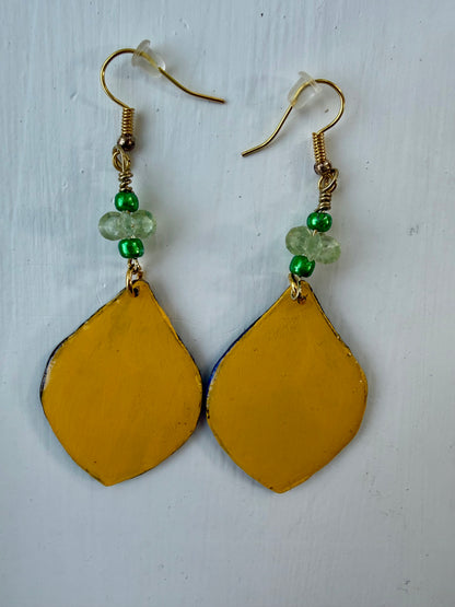 A pair of teardrop-shaped dangle earrings with gold-coated metal hooks and green beads, featuring a yellow back, displayed on a white background.