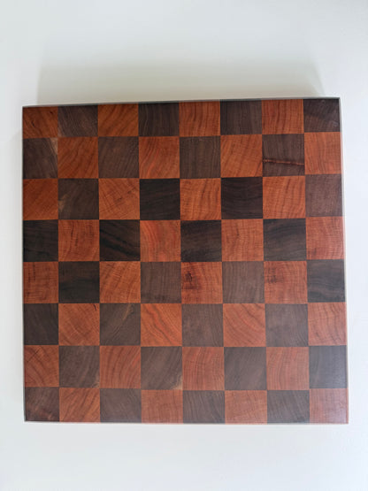 Square cutting board with a checkered cherry and walnut wood design