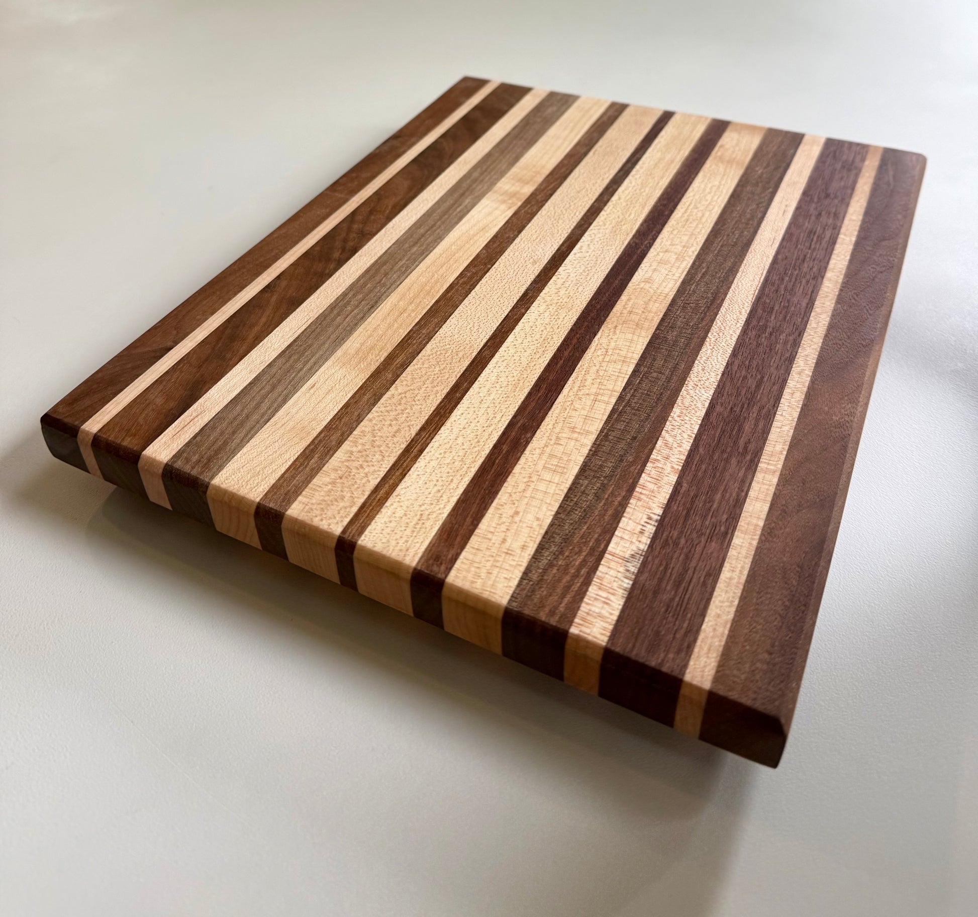 Wooden cutting board with striped pattern on a white background