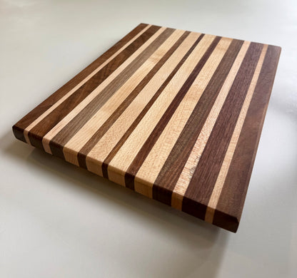 Wooden cutting board with striped pattern on a white background