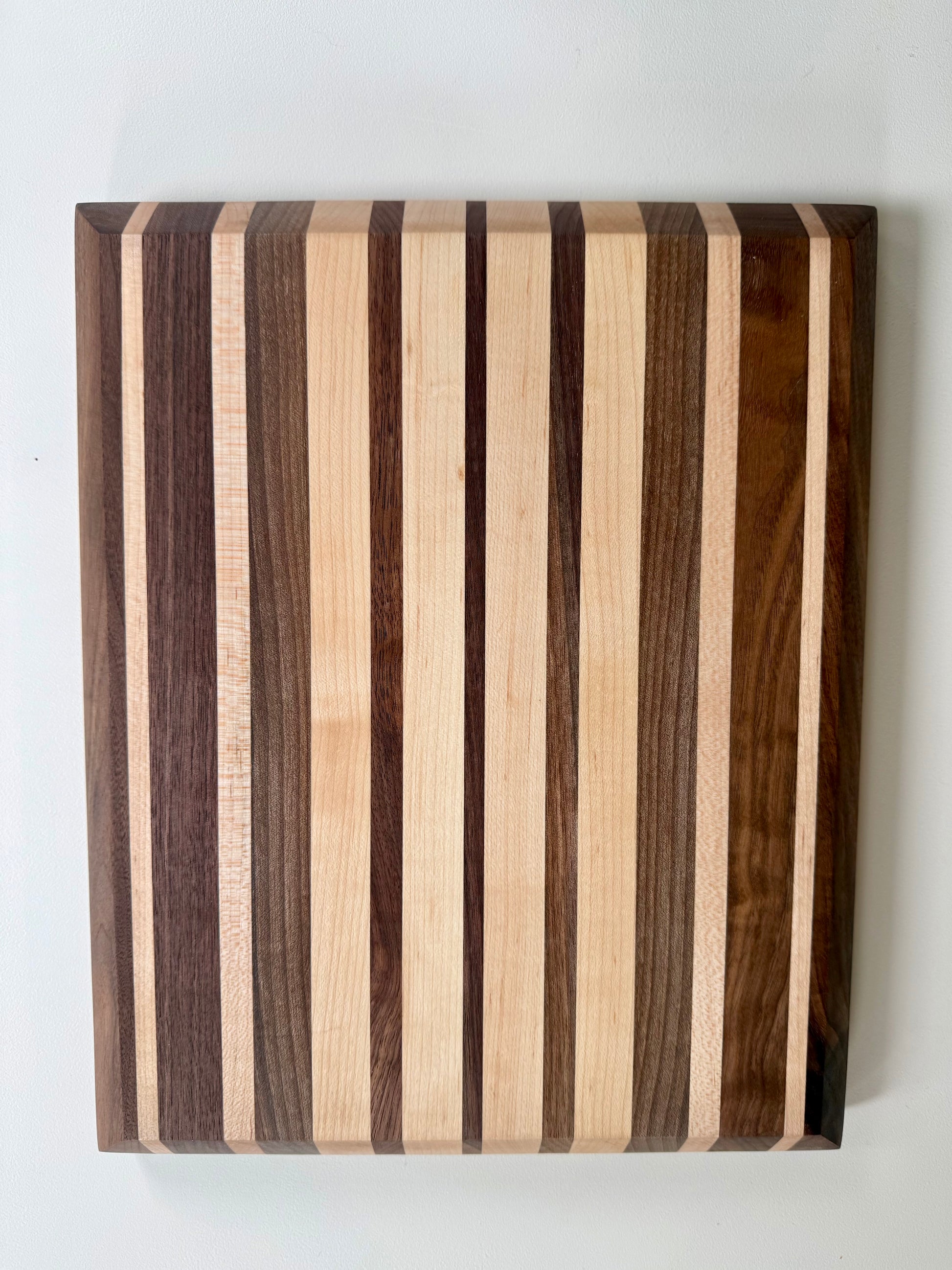 Wooden cutting board with striped pattern on a white background