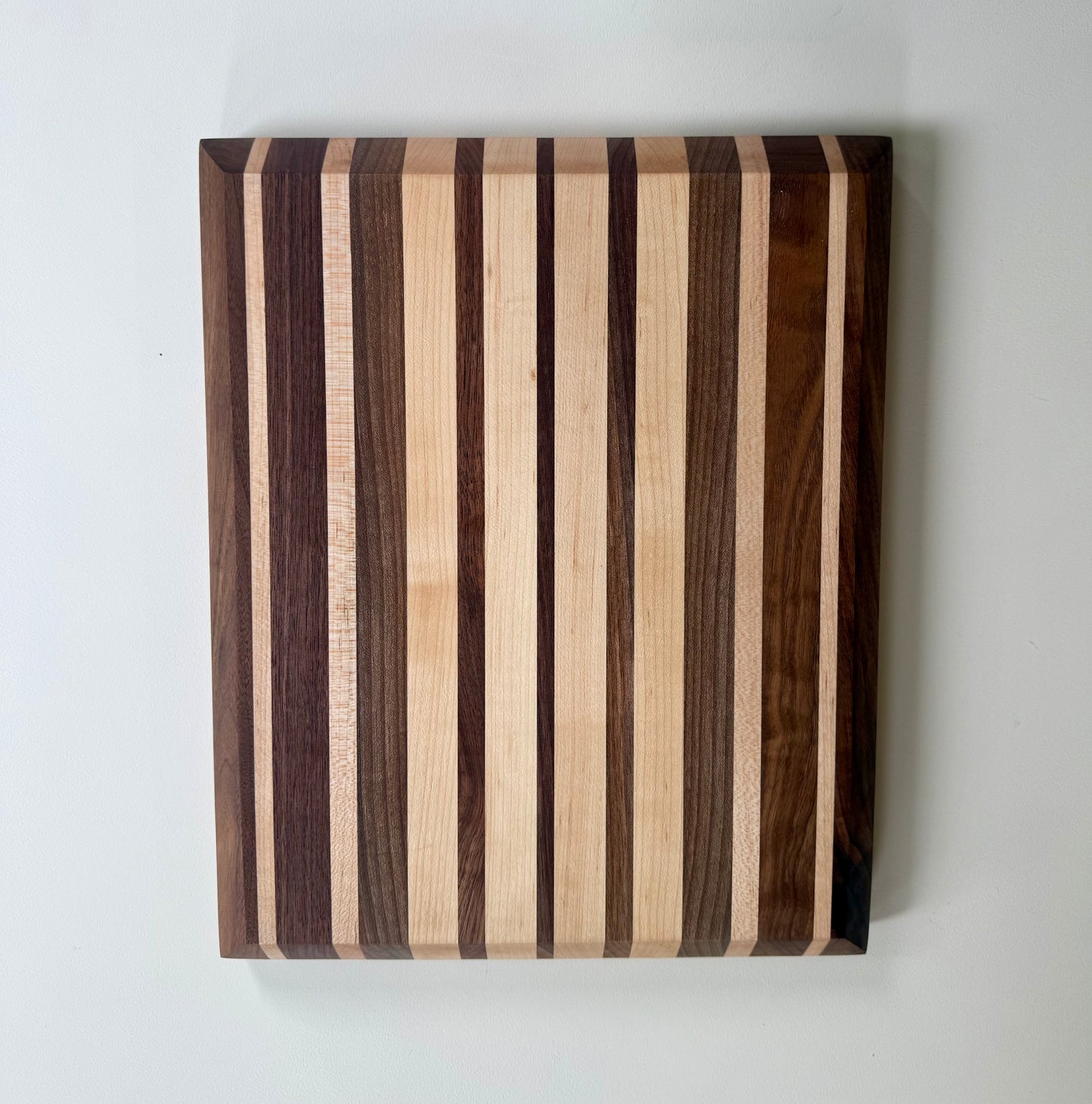 Wooden cutting board with striped pattern on a white background