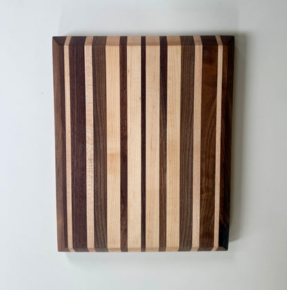 Wooden cutting board with striped pattern on a white background