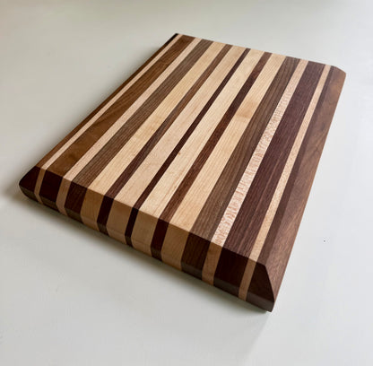 Wooden cutting board with striped pattern on a white background