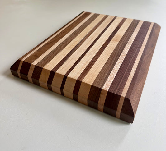 Wooden cutting board with striped pattern on a white background